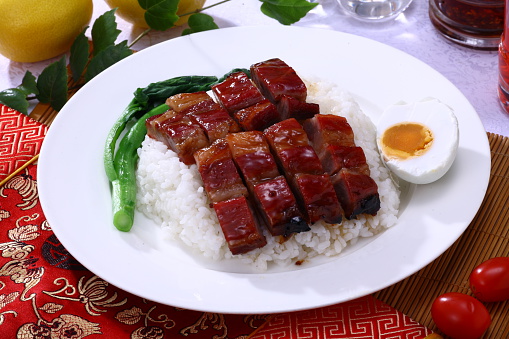 BBQ Pork with Honey Sauce (蜜汁叉烧) on rice with salted duck egg, a typical Hong Kong and Cantonese style cuisine in China.