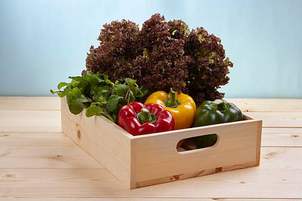 istock Fresh colorful bell pepper box on wooden table. Top view 611997140