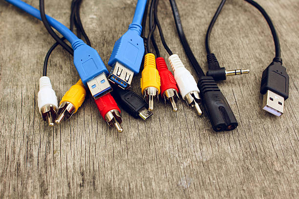 istock Connection plugs and wires on old wooden background. 611997734