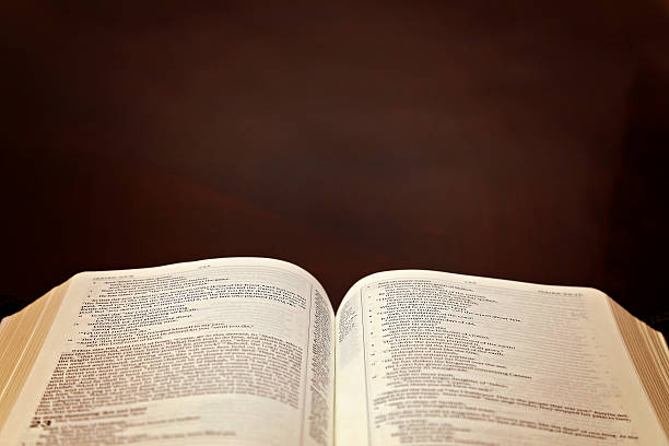 istock Holy Bible Open on a Wooden Table 611998820