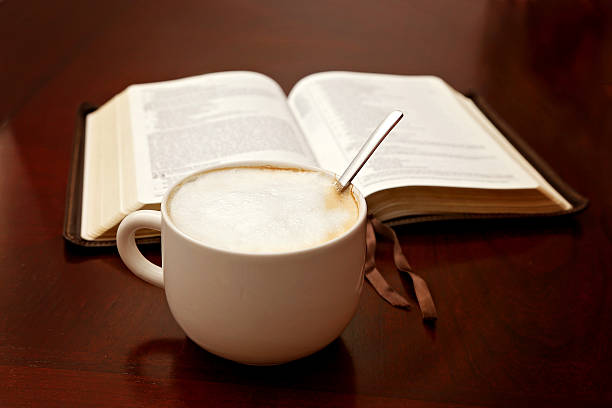 istock Holy Bible Open on a Wooden Table 611999188