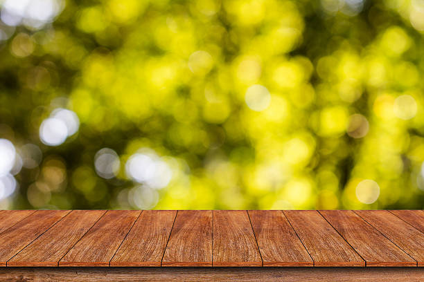 istock Wood table top on bokeh abstract background 612000228