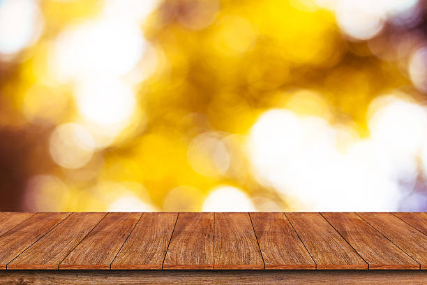 istock Wood table top on bokeh abstract background 612000264