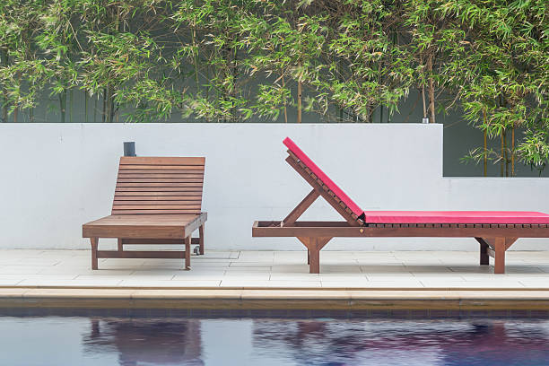 istock Wooden benchs beside the swimming pool 612000372