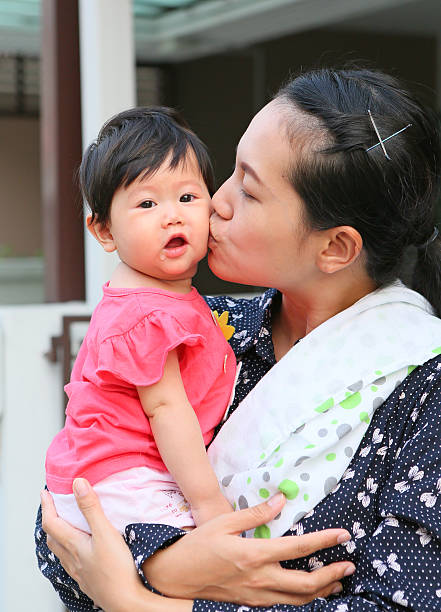 istock Mother kissing her baby 612001538