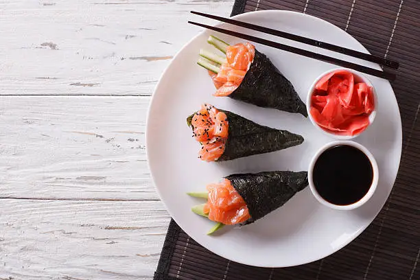 Photo of Japanese food: Salmon temaki, ginger and sauce. Horizontal top view