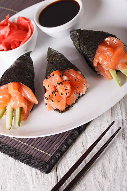 istock Temaki salmon on a plate close-up. Vertical 612004468