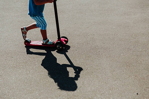 istock little girl riding scooter outdoors, active kids 612005812