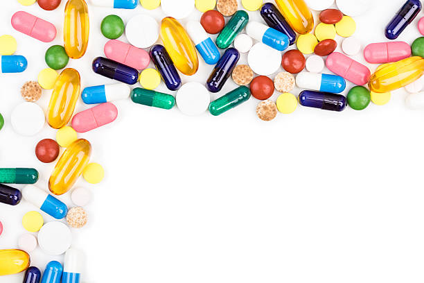 Various color pills and capsules stock photo