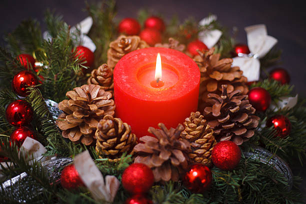 istock Decorated Christmas wreath with a candle close-up 612007156