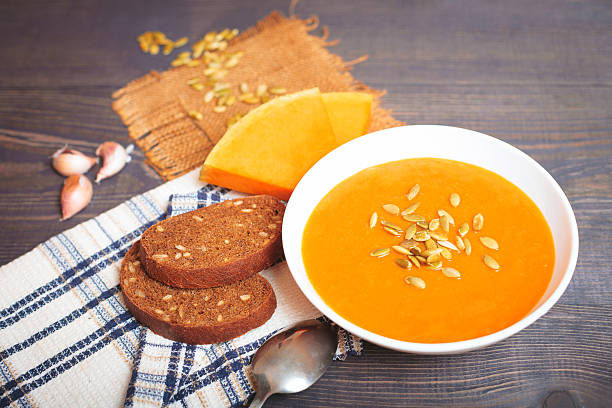 istock Pumpkin soup on a wooden table 612009828