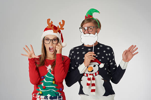 Couple ready for the Christmas time Couple ready for the Christmas time vintage nerd with reindeer sweater stock pictures, royalty-free photos & images