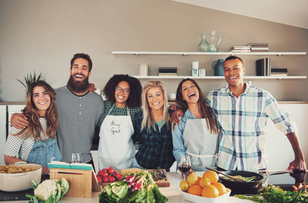 group of six adults at food preparation table - gourmet enjoyment food freshness imagens e fotografias de stock