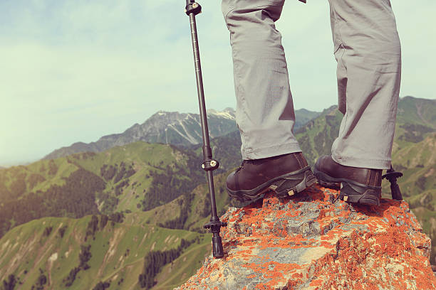 istock successful woman hiker hiking on mountain peak cliff 612010658