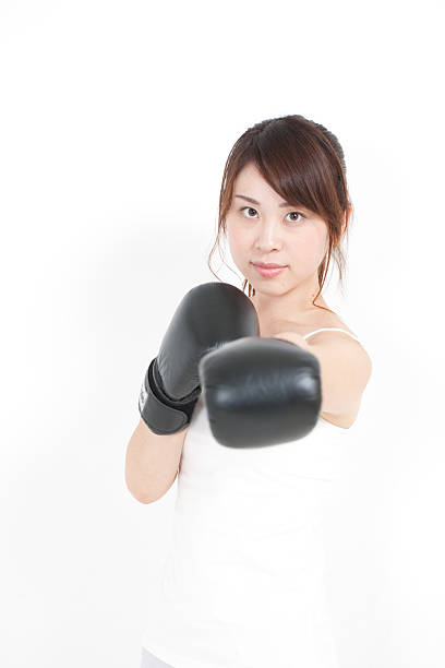 istock Woman wearing boxing gloves 612012128