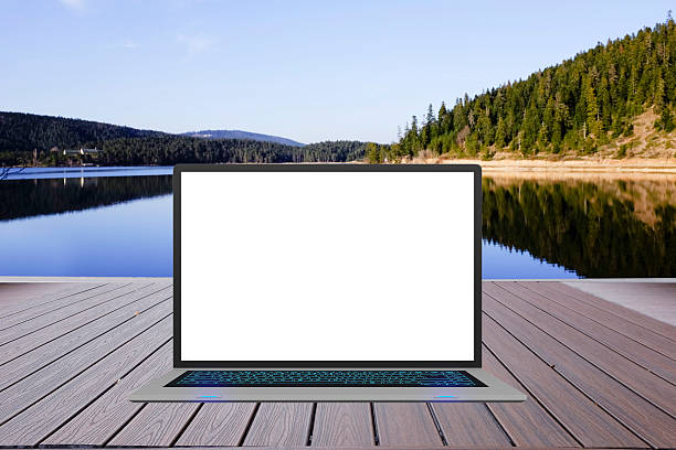 istock laptop computer on wooden floor, beautiful nature on background 612012772