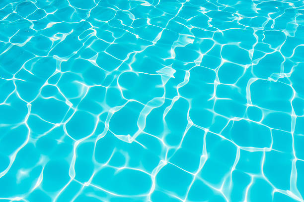 istock Ripple Water in swimming pool with sun reflection 612012880