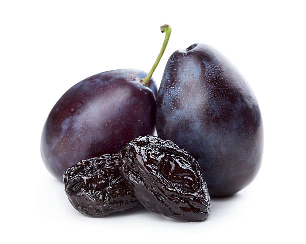 Plums and prunes Dried and fresh plums isolated on white background prune stock pictures, royalty-free photos & images