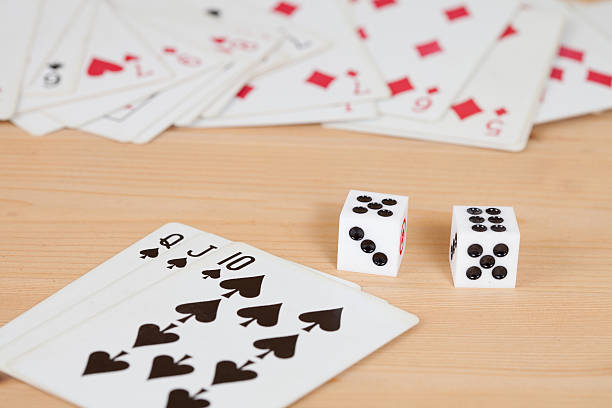 istock Two dices on wood table with card 612015072
