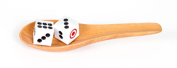 istock Two dices in wood spoon on white background 612015890