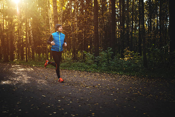 Man running in forest on sunrise