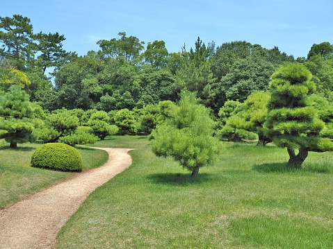 Kagawa, Japan - July 22, 2016: Walkway in Ritsurin Garden in Takamatsu city, Kagawa Prefecture, Japan. Ritsurin Garden is one of the most famous historical gardens in Japan.