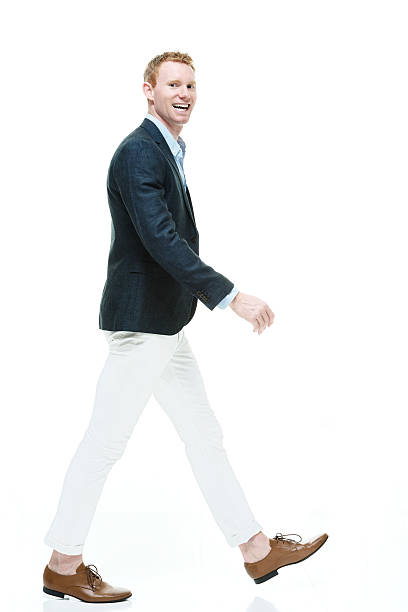istock Smiling fashionable man walking 612017738