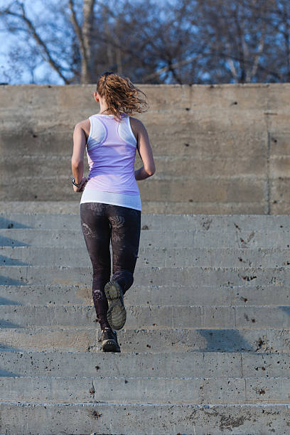 istock sporty woman running onsteps 612018090