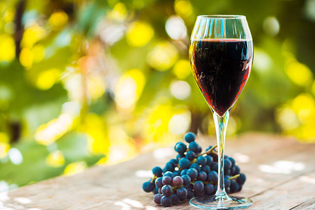 istock Glass with red wine on the wooden table 612019356