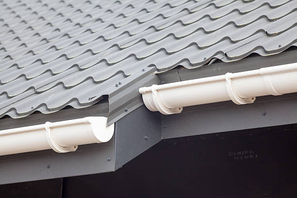 istock New gray metal tile roof with white rain gutter 612019396