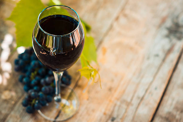 istock Glass with red wine on the wooden table 612020230