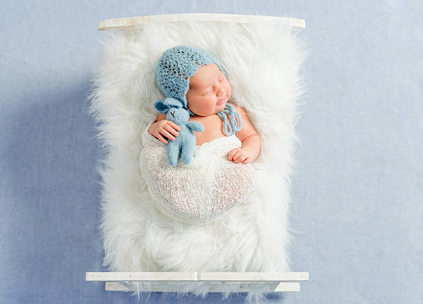 istock dreamy newborn boy holding toy sleeps 612020494