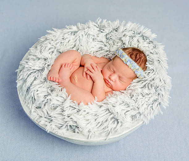istock funny newborn girl with headband 612020644
