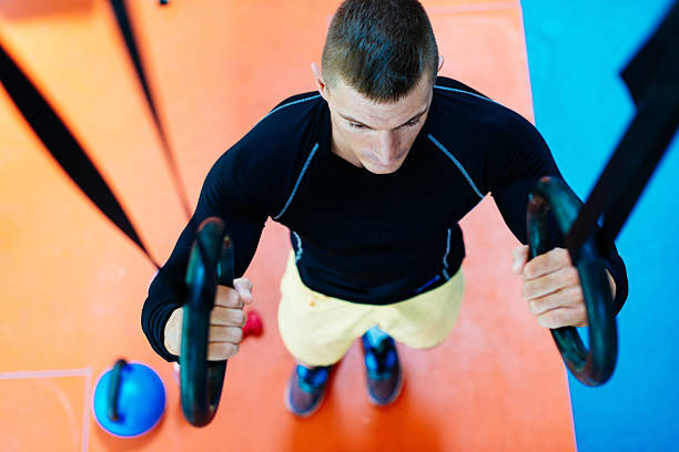 istock athlede doing chin ups on gymnastic rings during cross training 612021200