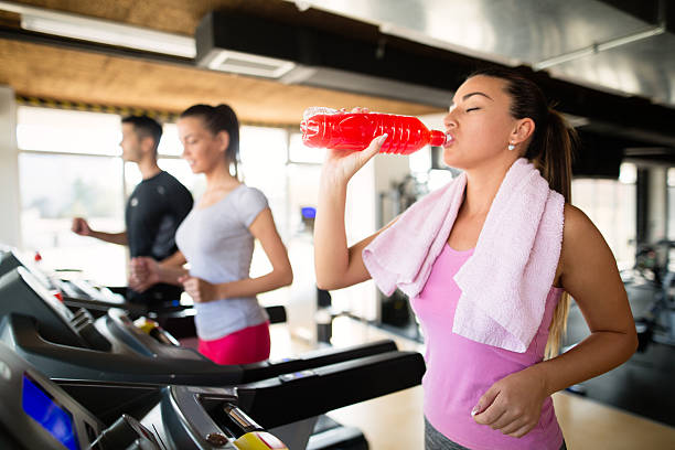 istock Young woman refreshing during training on treadmill. 612023072