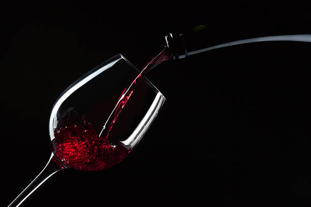istock bottle and glass with red wine 612023802