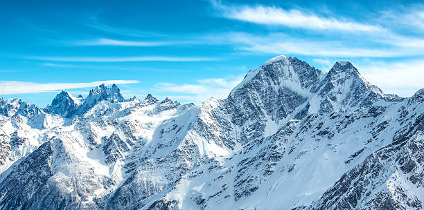istock Panorama of white mountains in snow 612024554