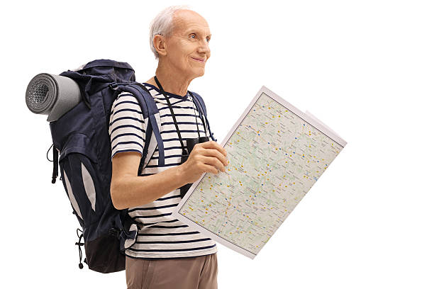 istock Male hiker holding a map and looking in the distance 612025354