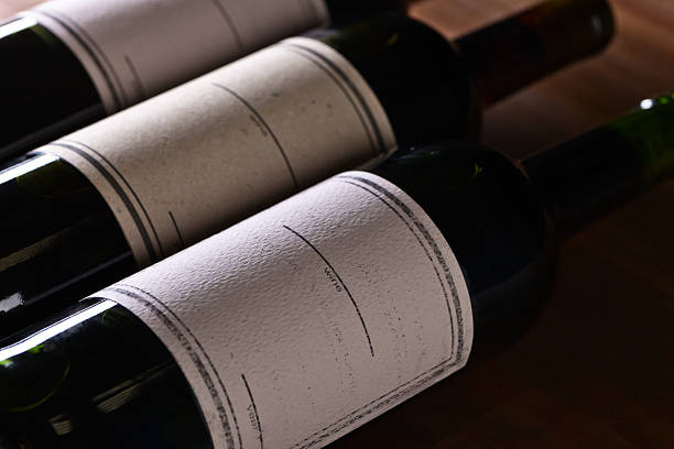 The bottles of red wine on old wooden table
