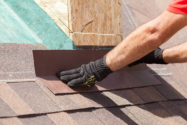 istock Roofer builder worker installing shingles on a new wooden roof 612025450