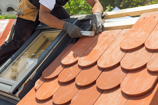 Natural roof tile instaalation. Roof with mansard windows.