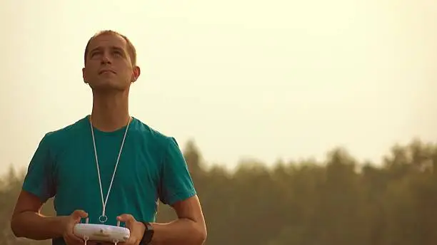 Photo of Man with RC remote launching drone