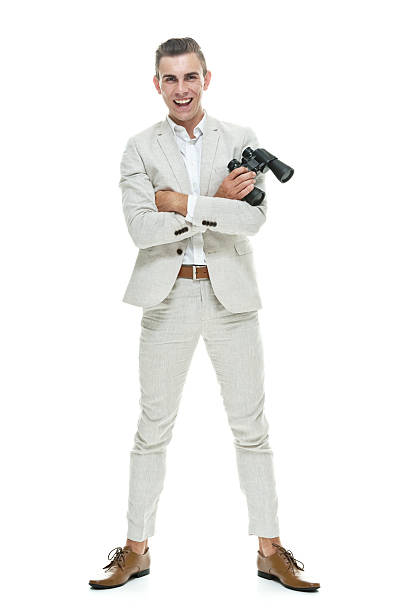 Smiling smart casual man holding binocular