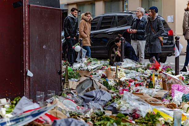 Tribute to terrorism victims in Paris Paris, France - November 21, 2015: Drawings, flowers and messages paying tribute to terrorism victims in Paris. islamic state stock pictures, royalty-free photos & images