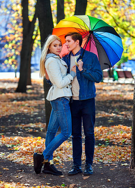 istock Loving couple on date under umbrella. 612031650