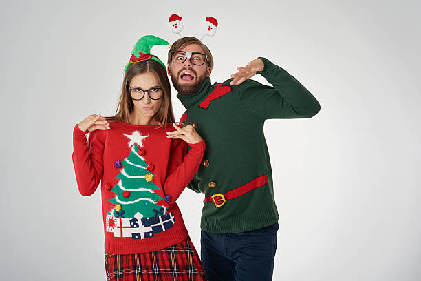 Christmas couple and funny poses Christmas couple and funny poses christmas nerd sweater cardigan stock pictures, royalty-free photos & images