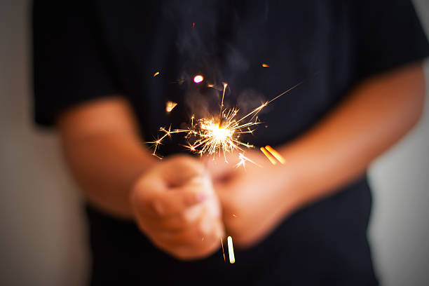 istock Boy Is Holding A Roman Candle For Birthday 612032156