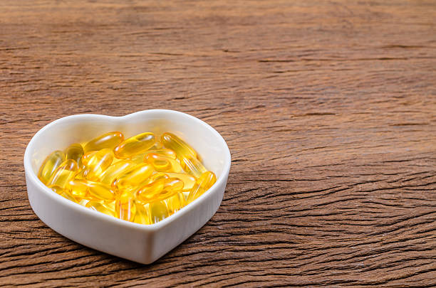 istock fish oil in heart shape bowl 612222812