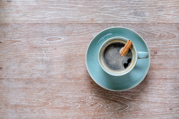 istock Coffee cup on wooden table with cinnamon and brown sugar. 612223246