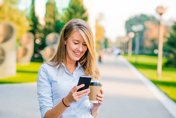 istock Confident women reading information about finance news while wal 612223936
